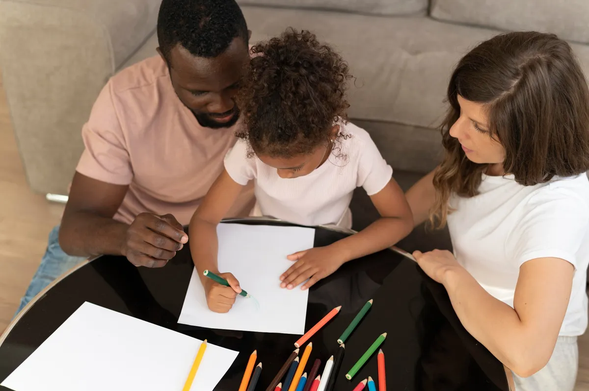 Parents working with their child on school work at home