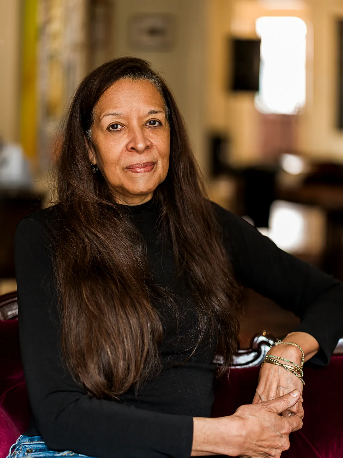 Portrait of Dr. Pamela Brown seated on a velvet sofa